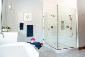 White bathroom with tile shower and standalone bathtub