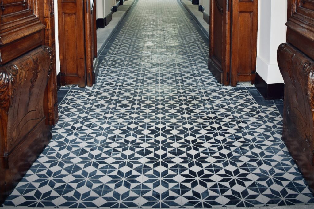 Bold patterned tile with wood trim in hallway