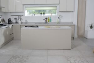 Modern white kitchen with elegant tile flooring