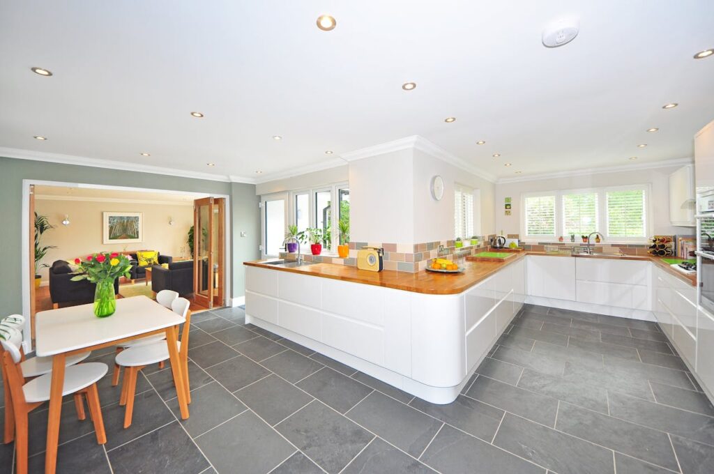 Gray large format tiles in modern, white kitchen