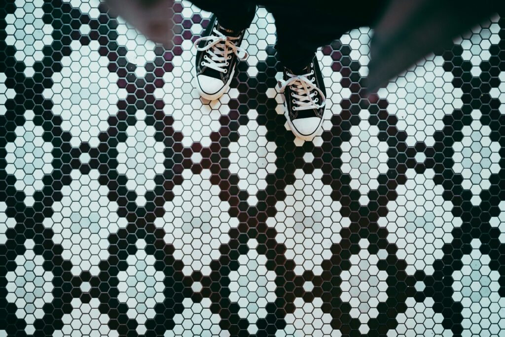 Person standing on hexagon floor tiles