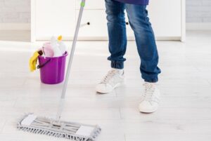 Man mopping tile flooring