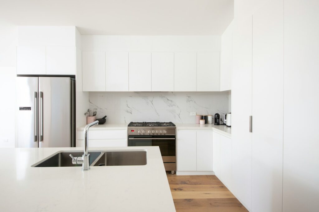 White kitchen with marble trendy kitchen backsplash