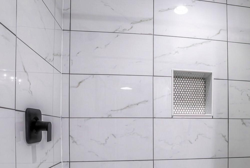 White stacked shower tiles with dark grout