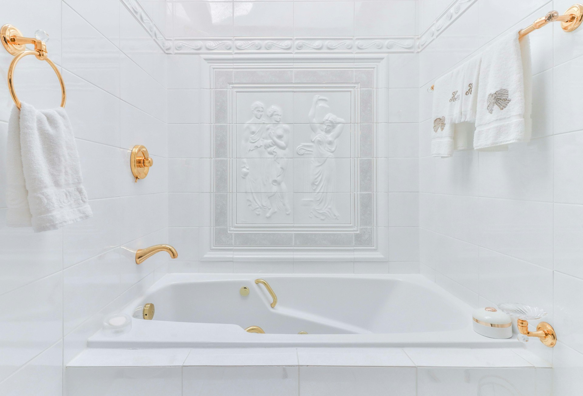 All white tiles and grout on tub surround