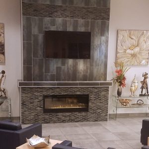 Tile fireplace makeover with gray contrasting tiles and dark furniture